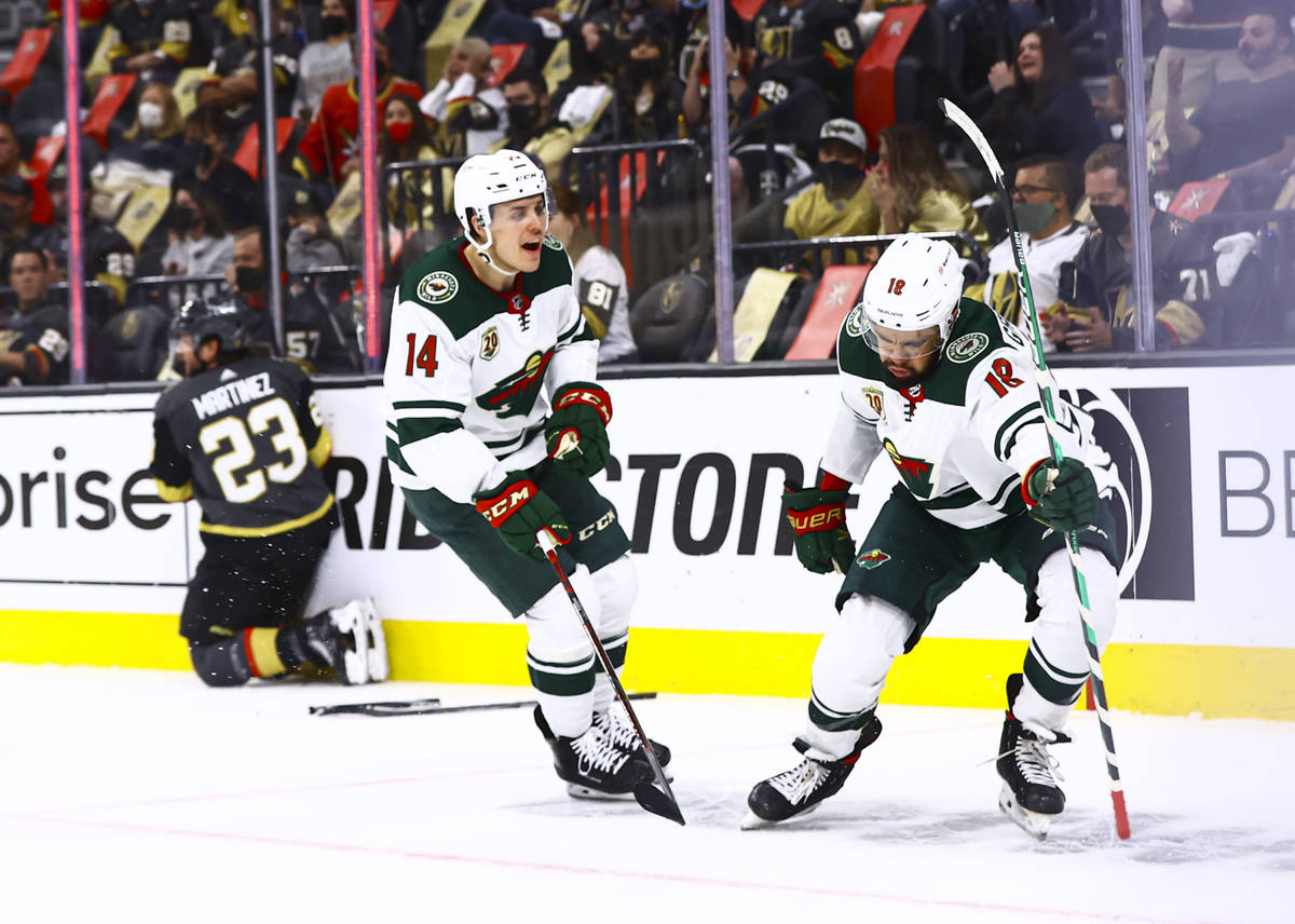 Minnesota Wild's Jordan Greenway (18) celebrates his goal alongside Joel Eriksson Ek (14) durin ...