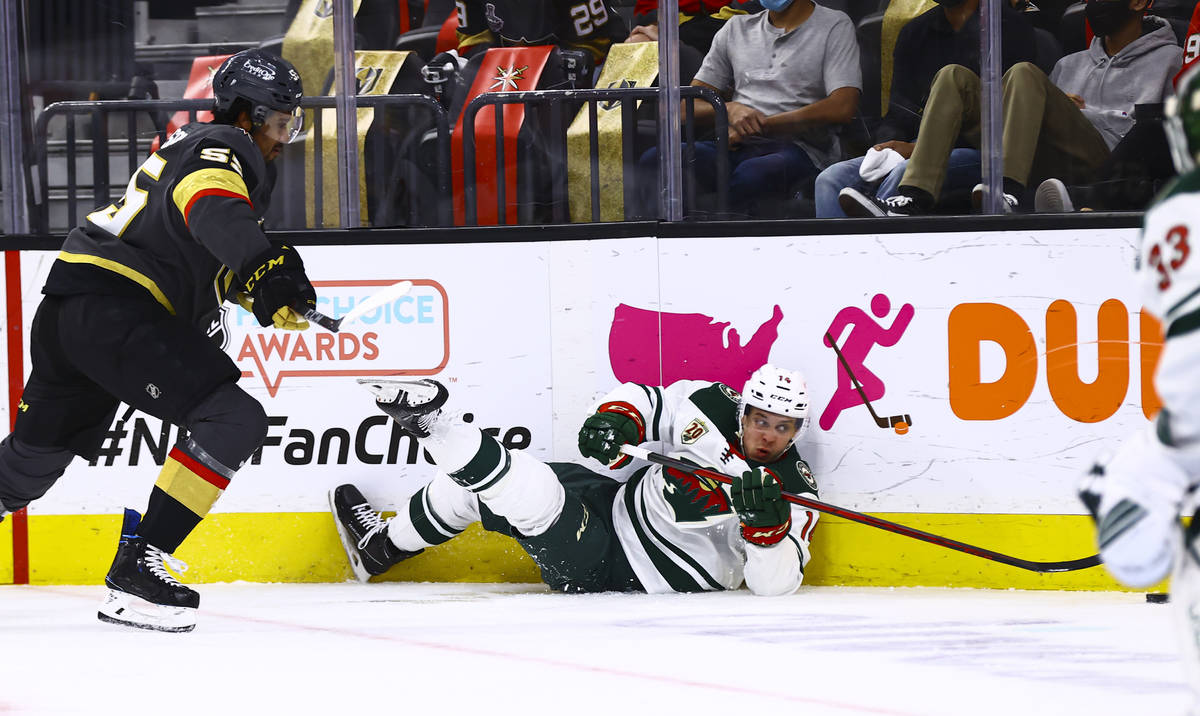 Minnesota Wild's Joel Eriksson Ek (14) gets tripped up in front of Golden Knights' Keegan Koles ...