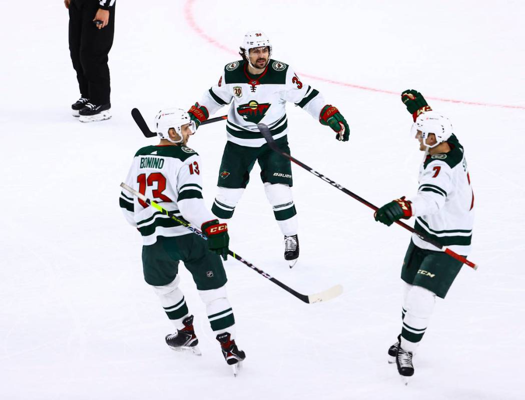 The Minnesota Wild celebrate an empty net goal against the Golden Knights during the third peri ...