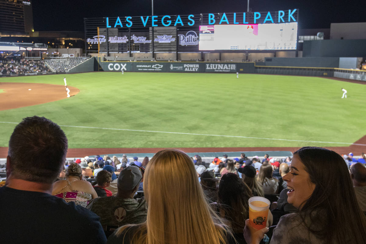 Jamie Lewis, right, laughs with her friend Nettie Byerly, center, during a Las Vegas Aviators g ...