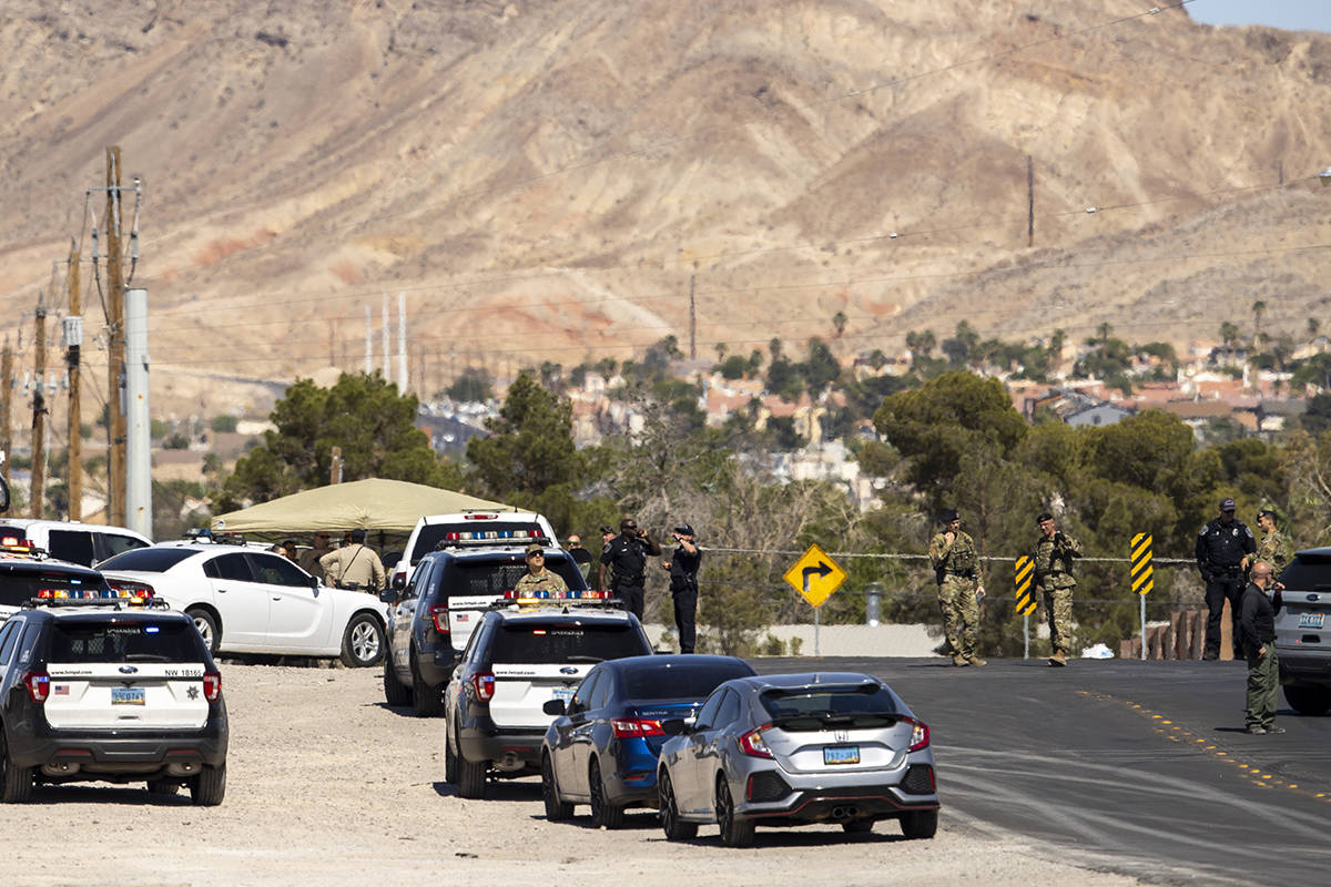 Metro officers and military personnel are near the scene of a Nellis Air Force Base jet crash o ...
