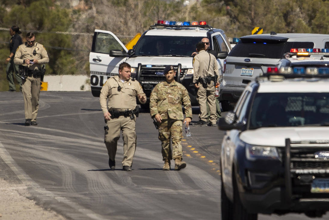 Metro officers and military personnel move about as they investigate a Nellis Air Force Base je ...