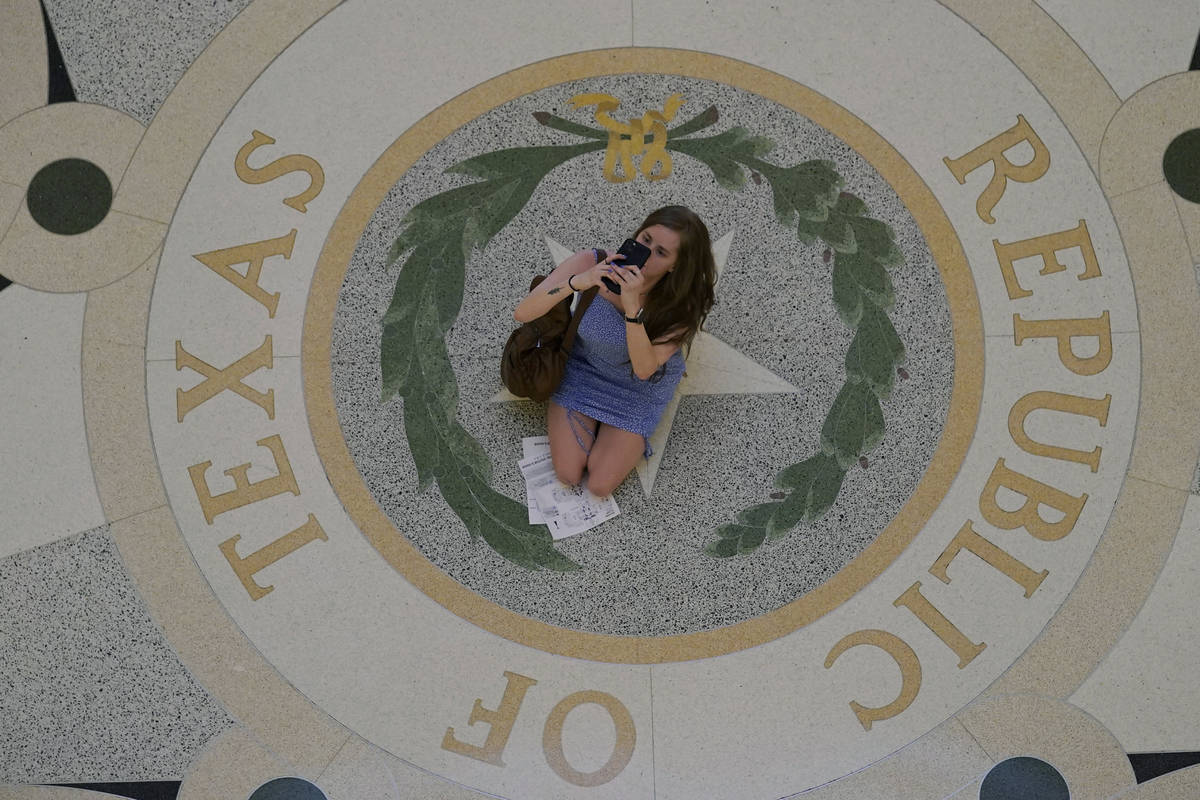 A visitor stops in the rotunda at the State Capitol to take photos, Thursday, May 20, 2021, in ...