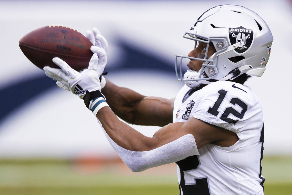 Raiders wide receiver Zay Jones (12) warms up before the start of an NFL football game against ...