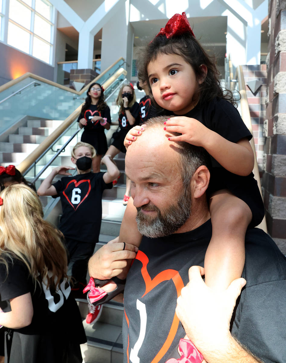 Joselyn Elizabeth Hairr, 2, takes in the festivities on the shoulders of her father Heath Hairr ...