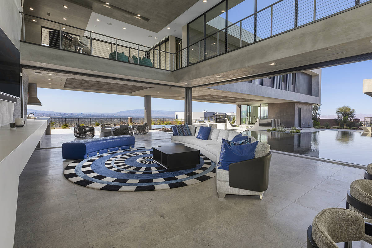 The living room opens to the pool. (Synergy Sotheby’s International Realty)