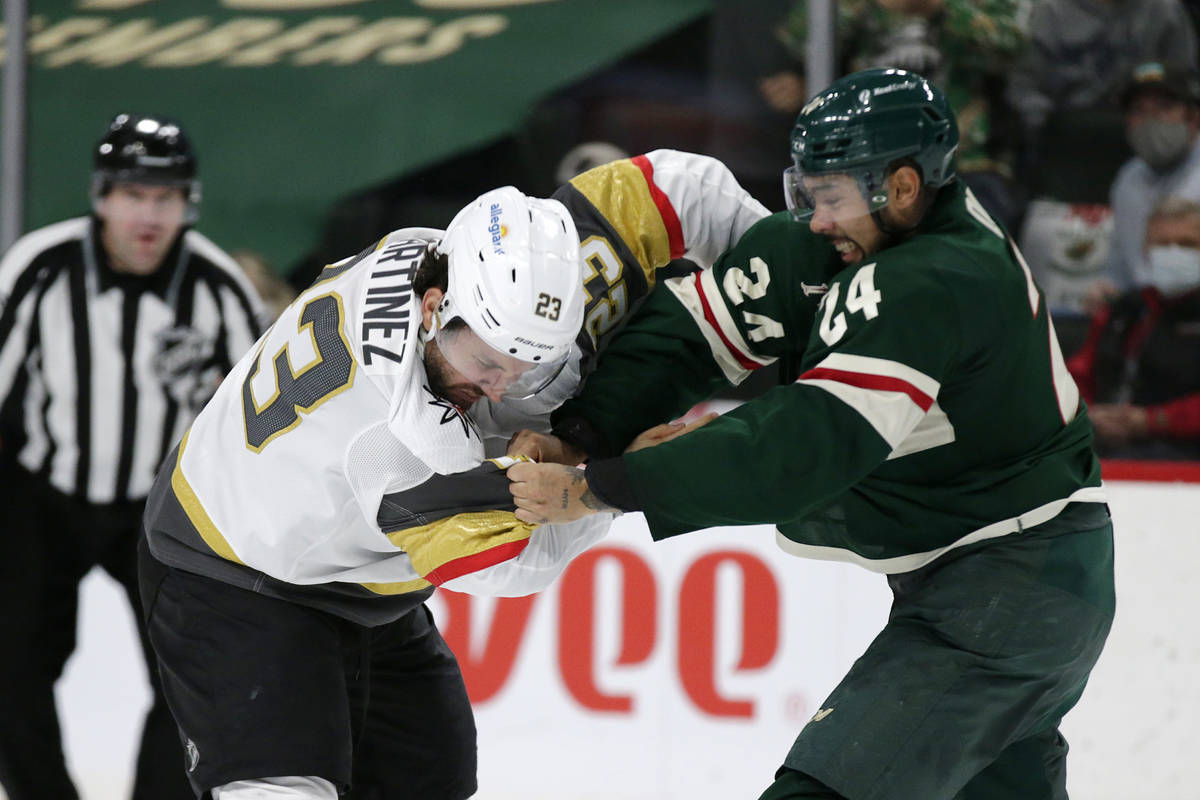 Minnesota Wild defenseman Matt Dumba (24) and Vegas Golden Knights defenseman Alec Martinez (23 ...