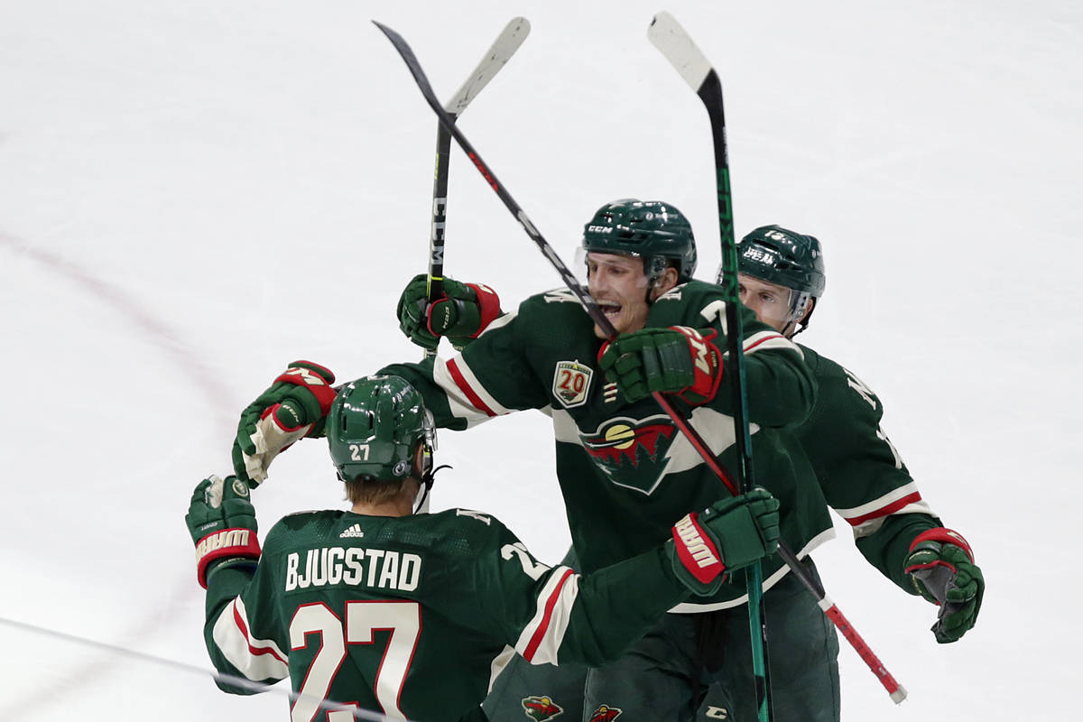 Minnesota Wild center Nick Bjugstad (27) is congratulated by teammates Nico Sturm (7) and Nick ...