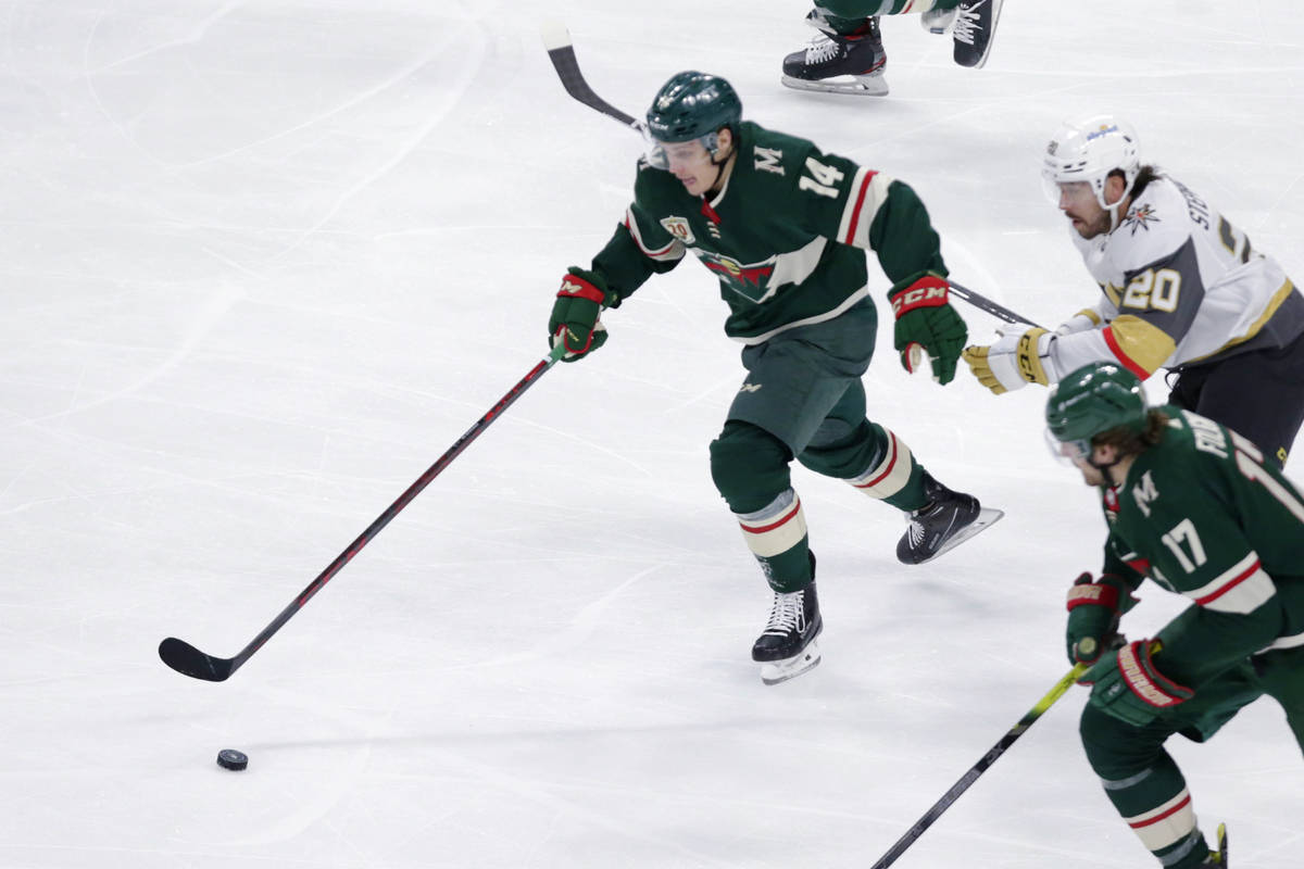 Minnesota Wild center Joel Eriksson Ek (14) controls the puck in front of Vegas Golden Knights ...