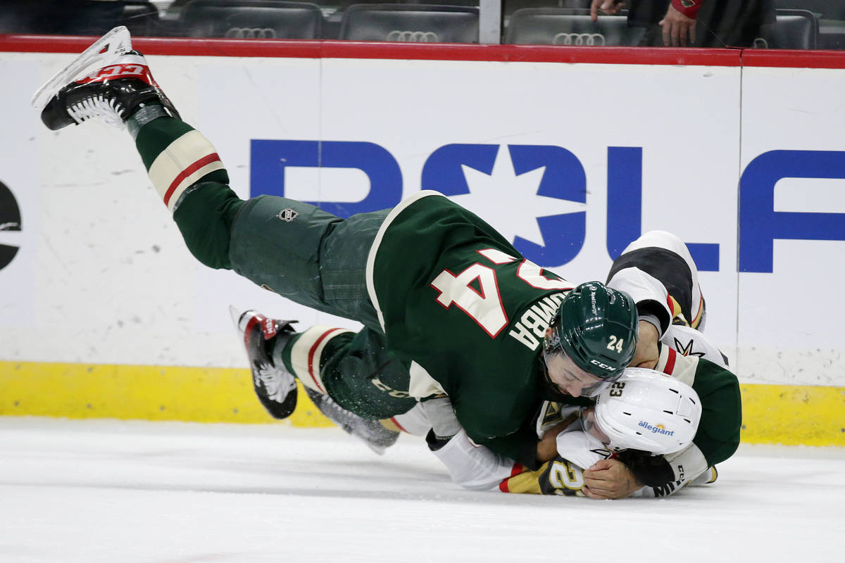 Minnesota Wild defenseman Matt Dumba (24) and Vegas Golden Knights defenseman Alec Martinez (23 ...