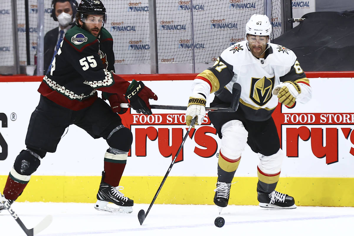 Golden Knights' Max Pacioretty (67) reaches out for the puck under pressure from Arizona Coyote ...