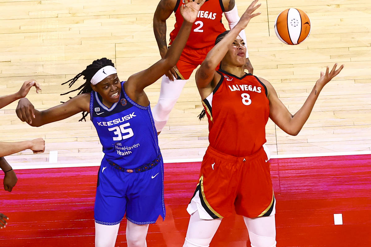 Las Vegas Aces' Liz Cambage (8) grabs a rebound in front of Connecticut Sun's Jonquel Jones (35 ...