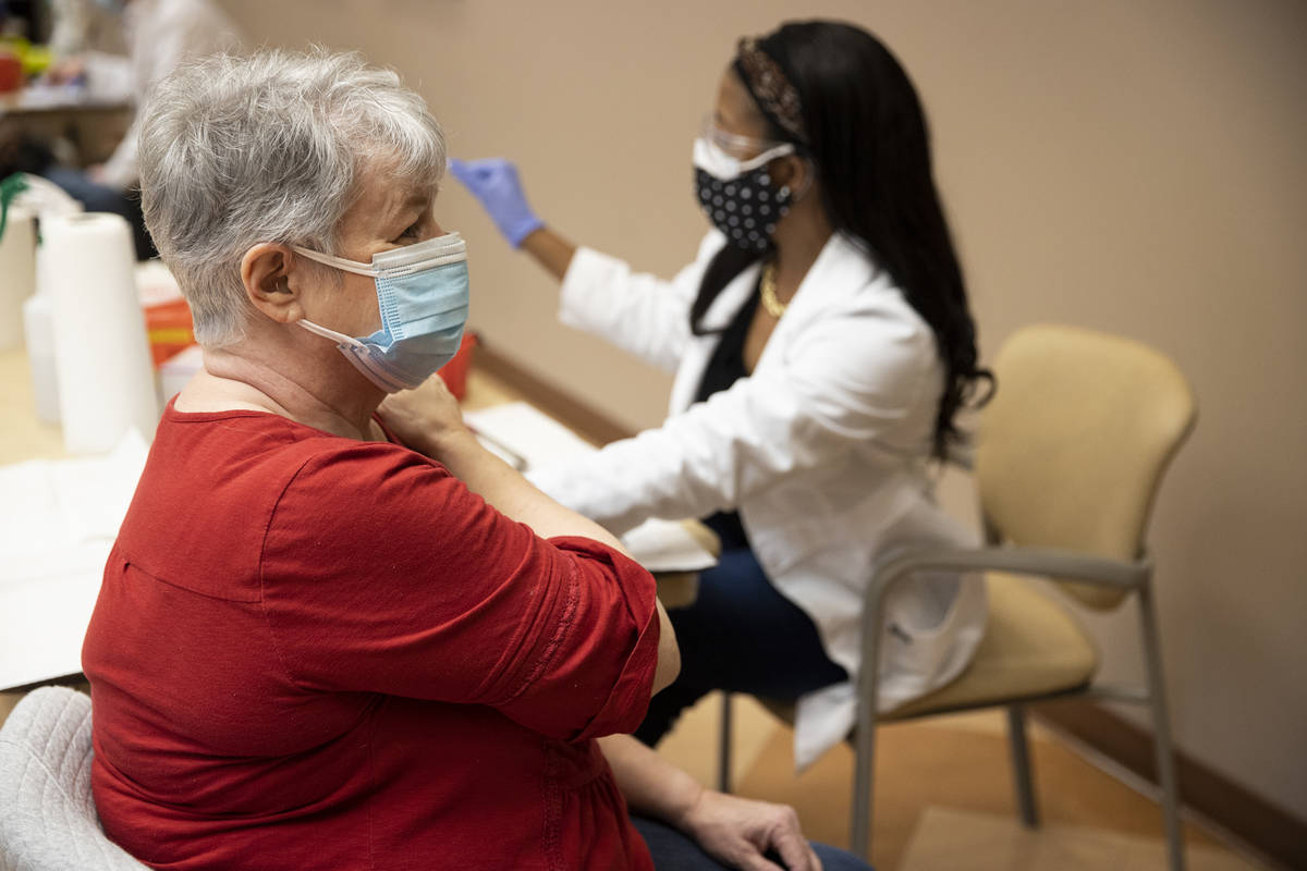 Donna Quick, 73, receives the COVID-19 vaccine from Dr. Christina Madison, associate professor ...