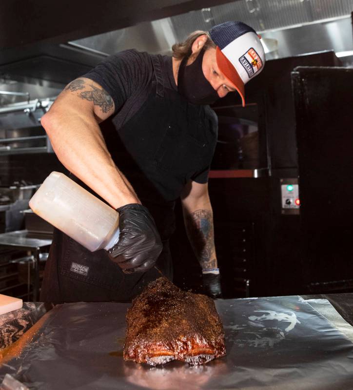 Joe Woodel, BBQ pitmaster, marinates smoked beef ribs at The Beast by Todd English, Area15 food ...