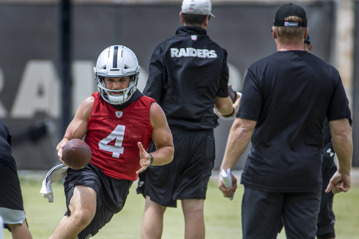 Quarterback Derek Carr (4) runs a drill as head coach Jon Gruden looks on during a Las Vegas Ra ...