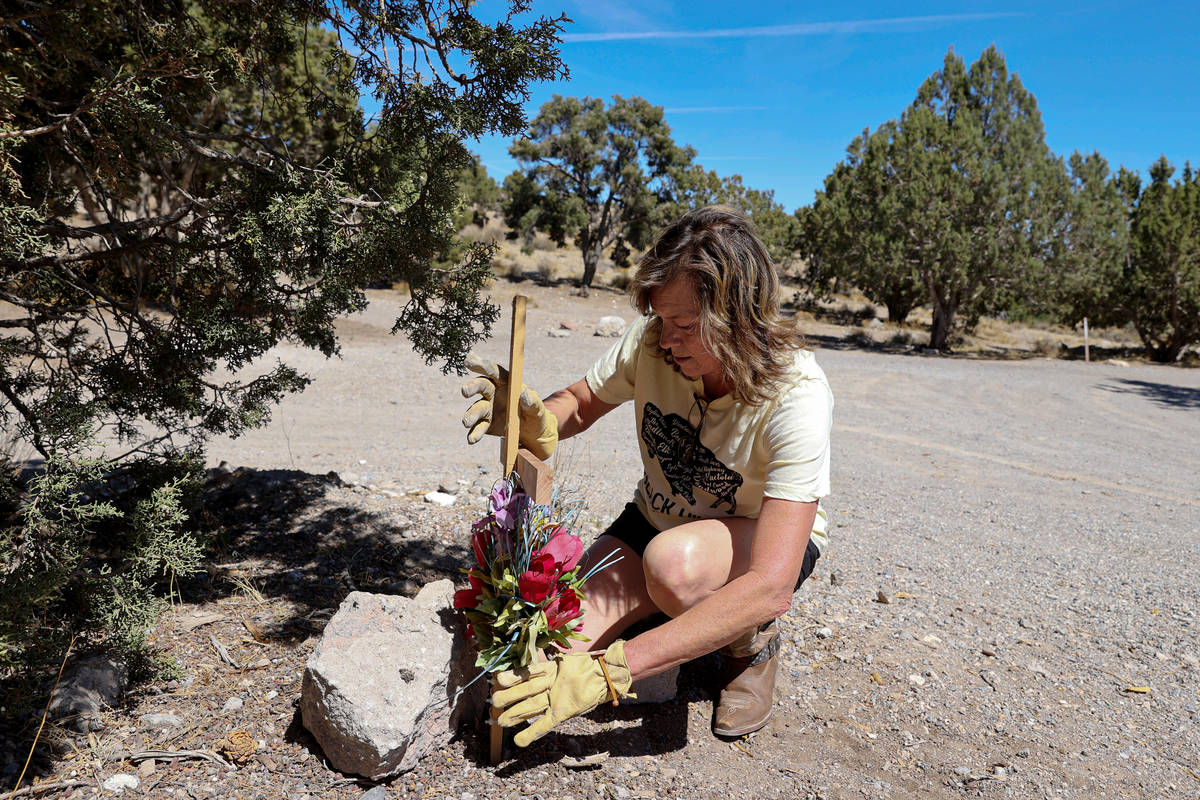 Anna Jones creates a makeshift memorial off Highway 160 in Mountain Springs near where the body ...