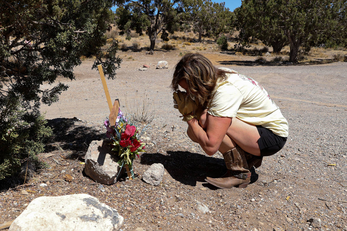 Anna Jones prays at a makeshift memorial off Highway 160 in Mountain Springs near where the bod ...
