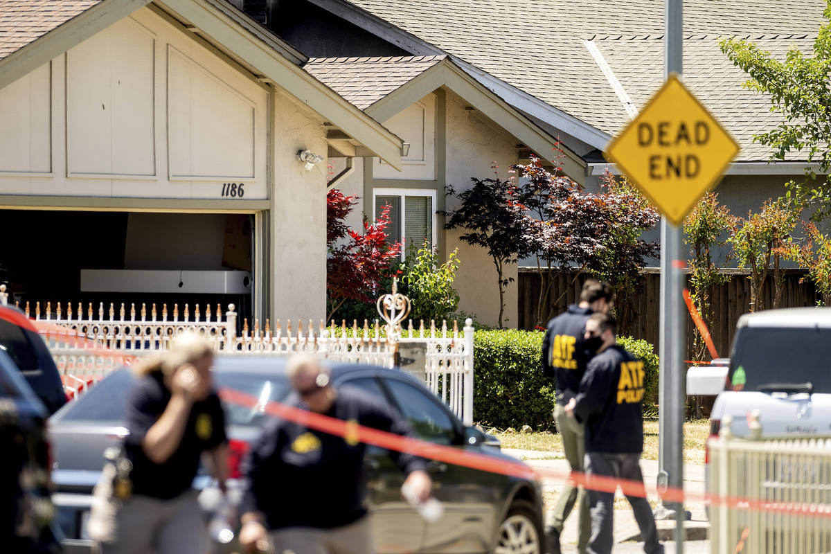 FBI agents approach a home, rear, being investigated in connection to a shooting at a Santa Cla ...