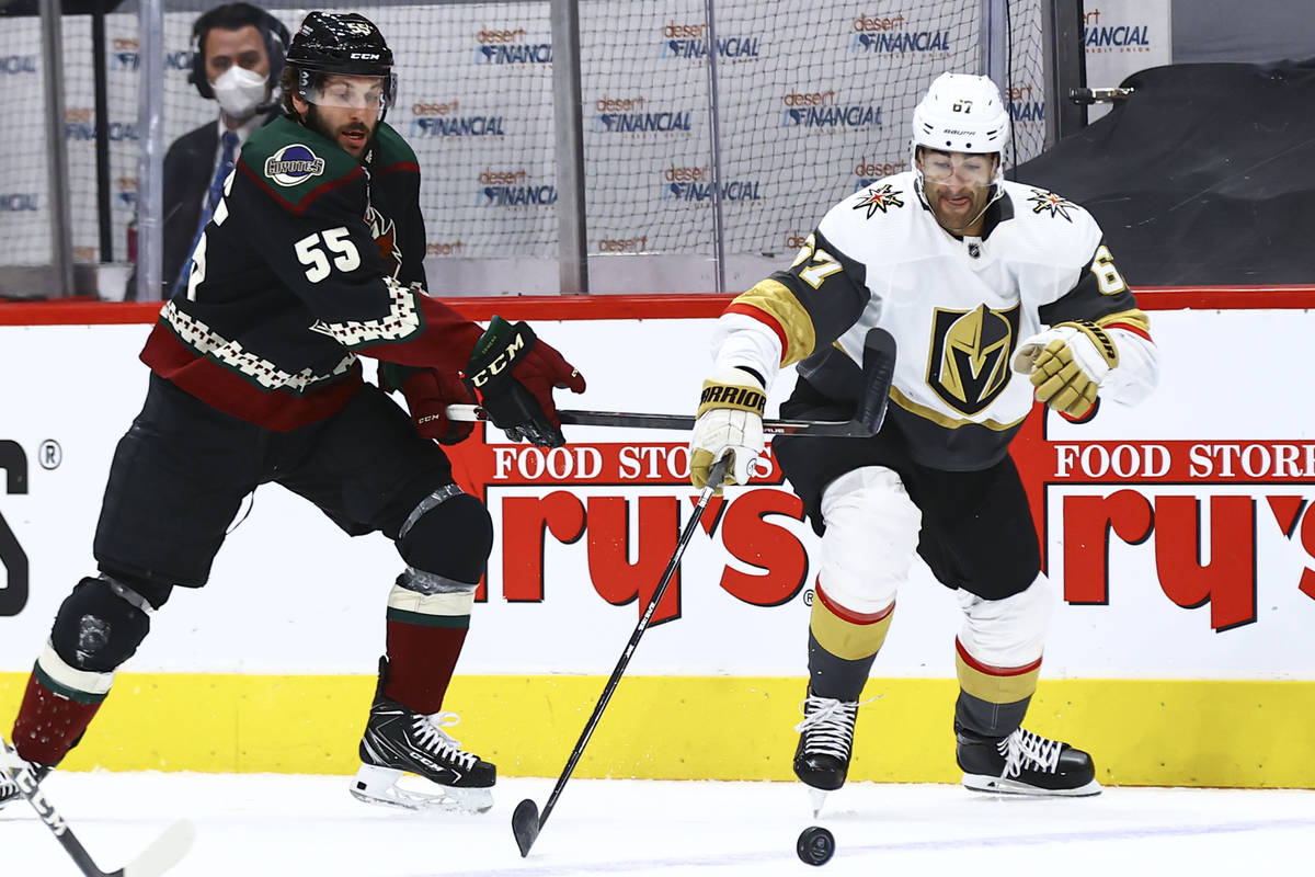 Golden Knights' Max Pacioretty (67) reaches out for the puck under pressure from Arizona Coyote ...