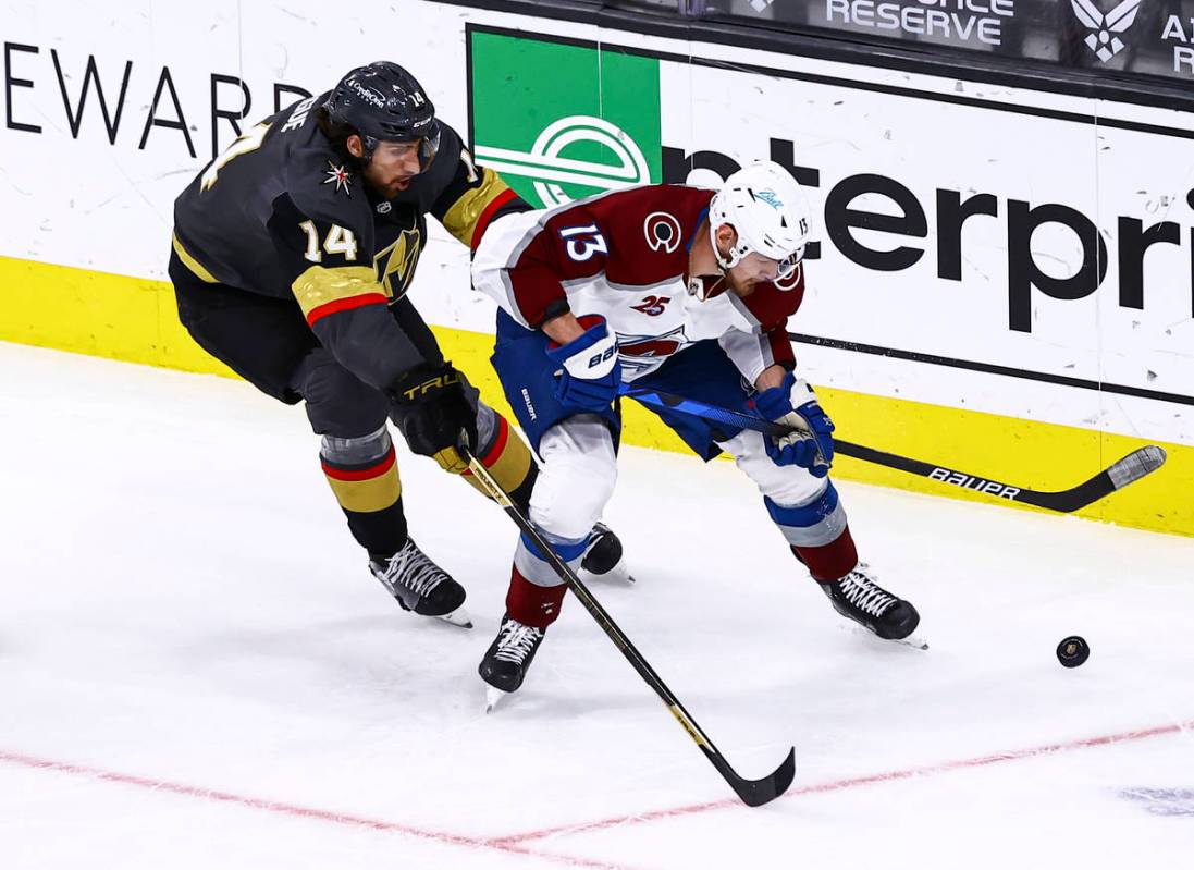 Colorado Avalanche's Valeri Nichushkin (13) skates with the puck under pressure from Golden Kni ...