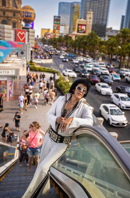 Chris Johnson, known as ÒCounterfeit Elvis,Ó makes his way up the escalator on The St ...