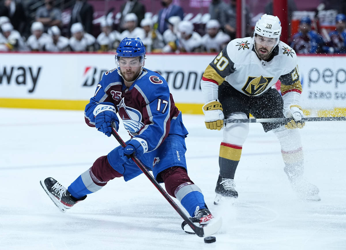 Colorado Avalanche center Tyson Jost (17) grabs the puck against Vegas Golden Knights center Ch ...