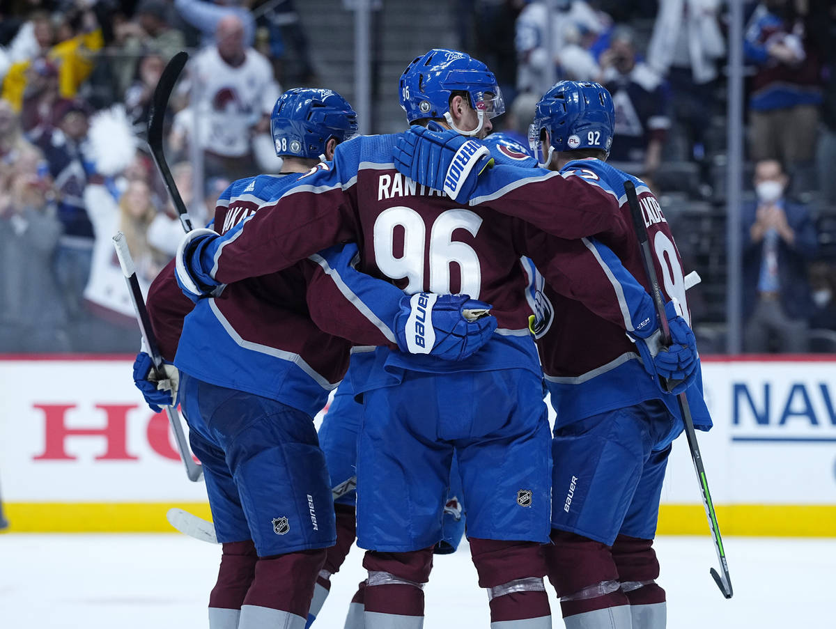 Colorado Avalanche left wing Gabriel Landeskog (92) is congratulated by teammates Cale Makar (8 ...