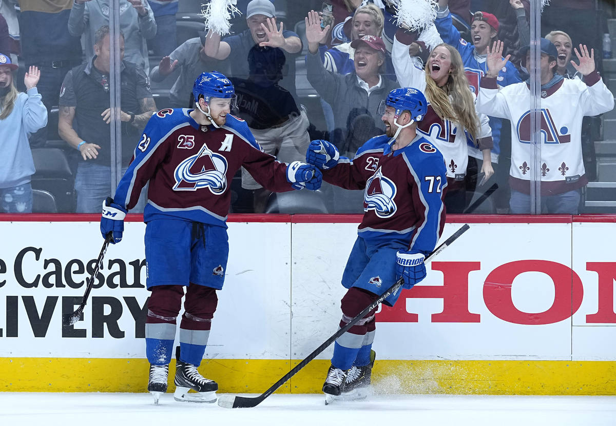 Colorado Avalanche center Nathan MacKinnon (29) is congratulated by teammate Joonas Donskoi (72 ...