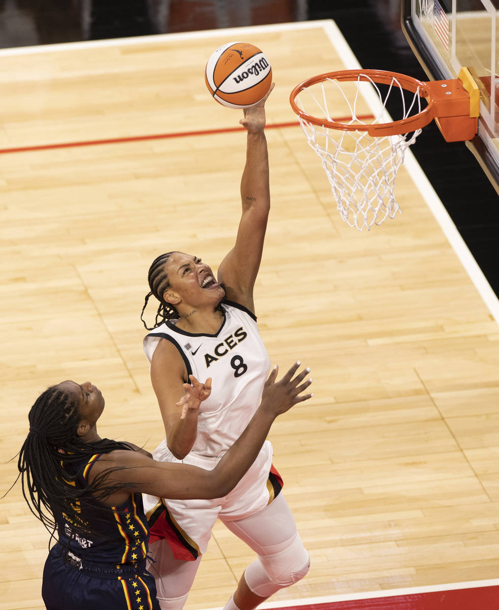 Las Vegas Aces forward Dearica Hamby (5) slices past Indiana Fever guard Kelsey Mitchell (0) an ...