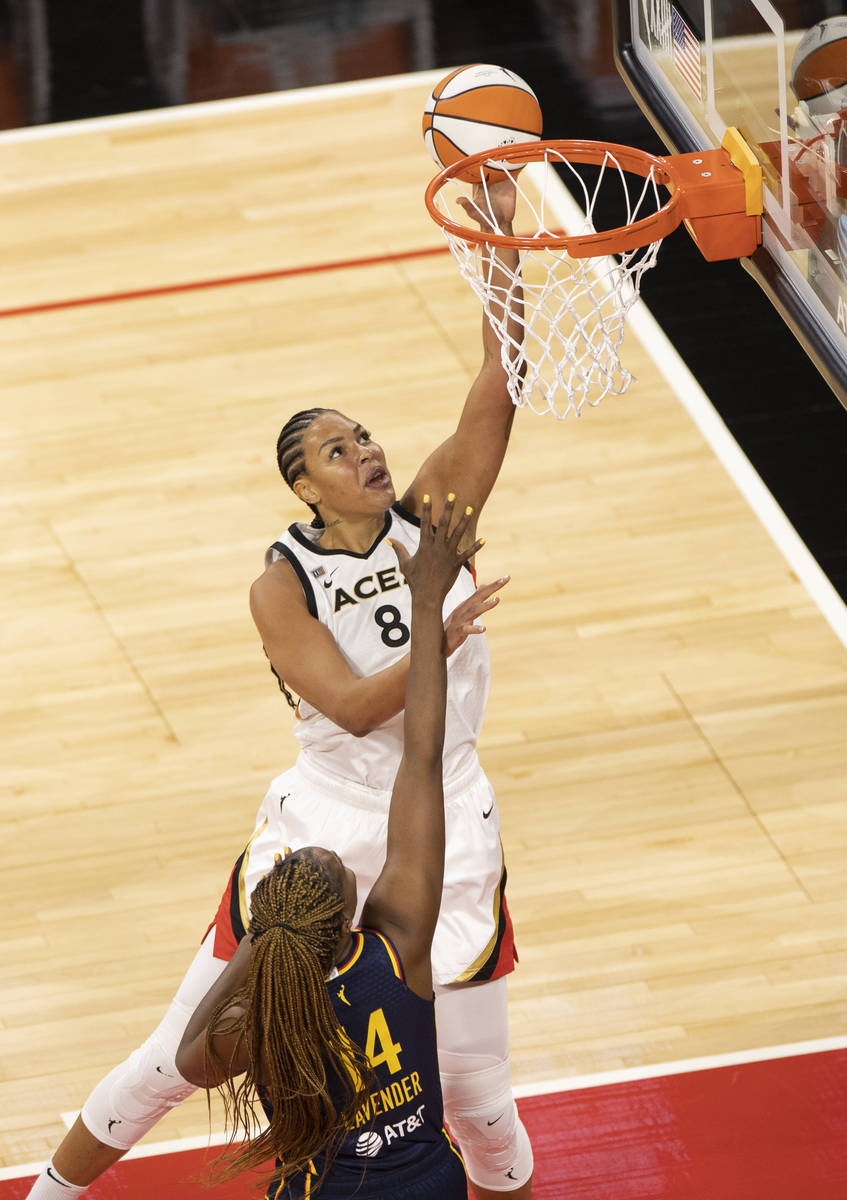 Las Vegas Aces center Liz Cambage (8) drives past Indiana Fever forward Jantel Lavender (14) in ...