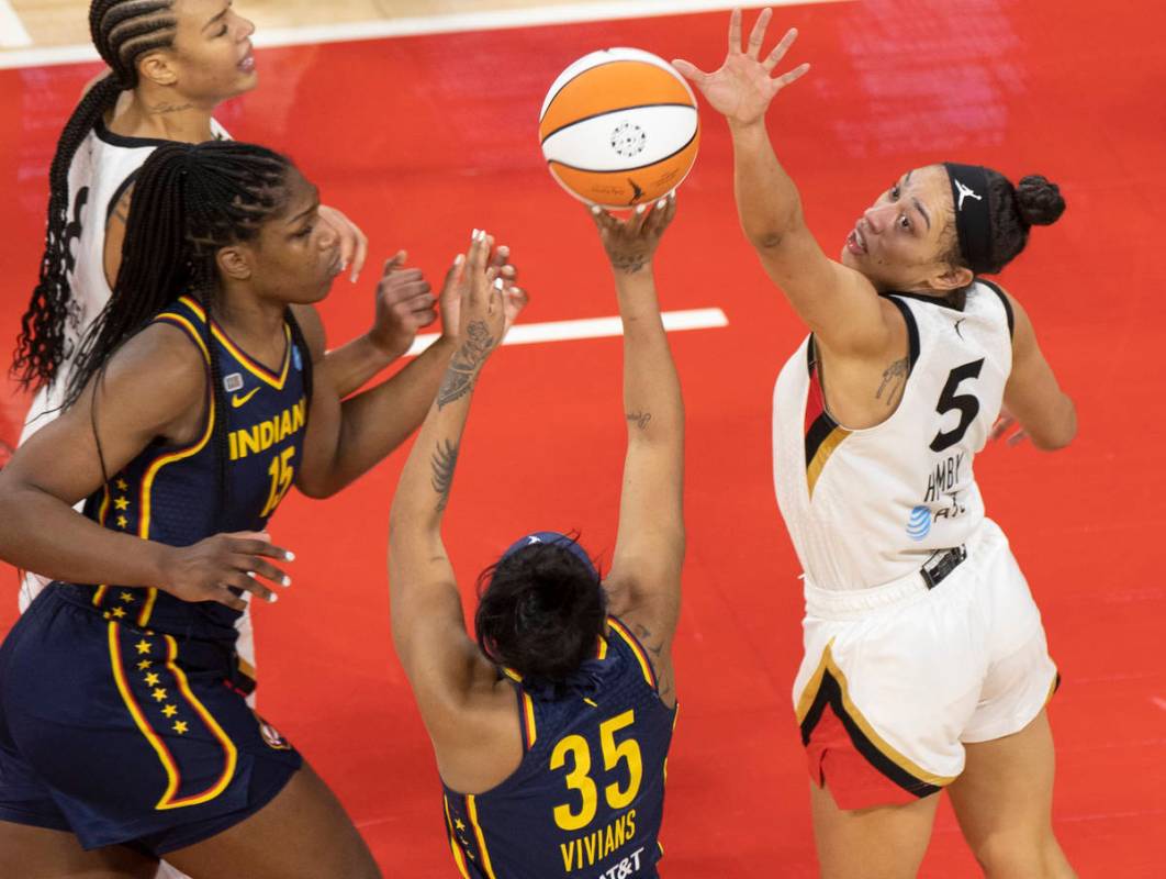 Las Vegas Aces forward Dearica Hamby (5) attempts to block the shot of Indiana Fever guard Vict ...