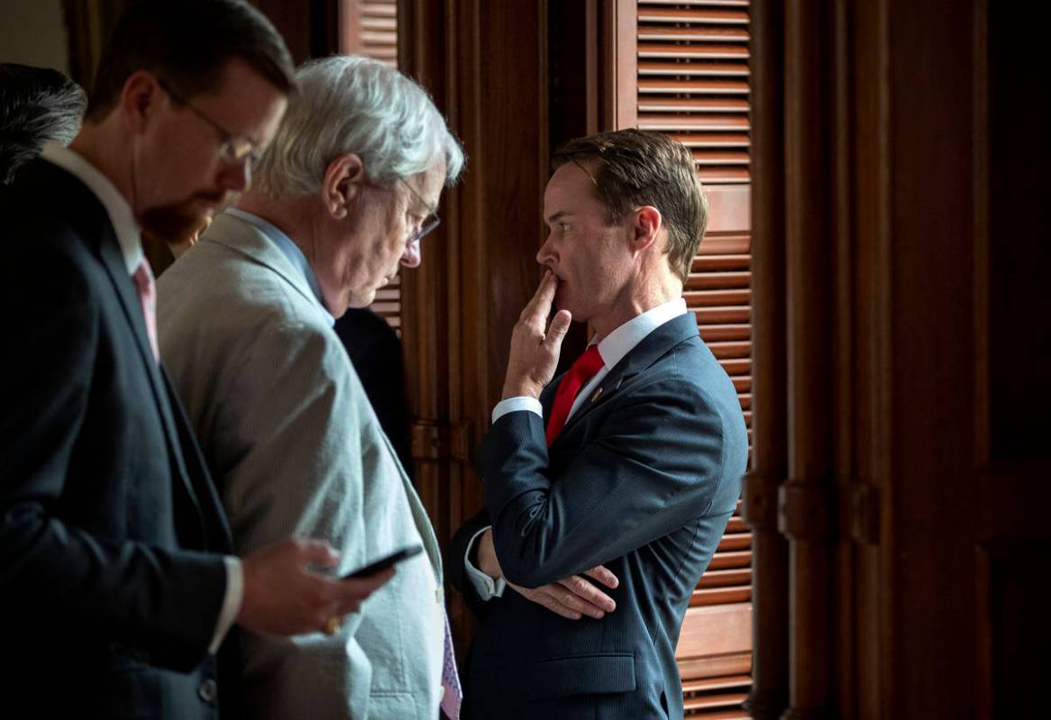 House Speaker Dade Phelan, R-Beaumont, right, talks to Republican members of the Texas House be ...