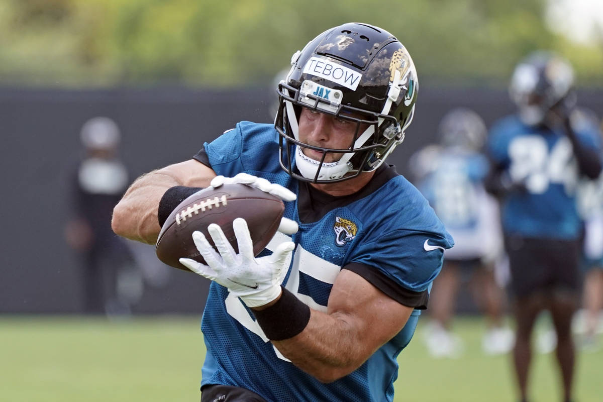Jacksonville Jaguars tight end Tim Tebow catches a pass during NFL football practice, Thursday, ...