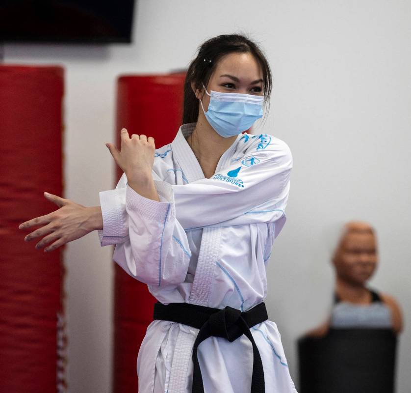 Trinity Allen stretches at her father's karate studio. Allen is preparing to qualify for the U. ...