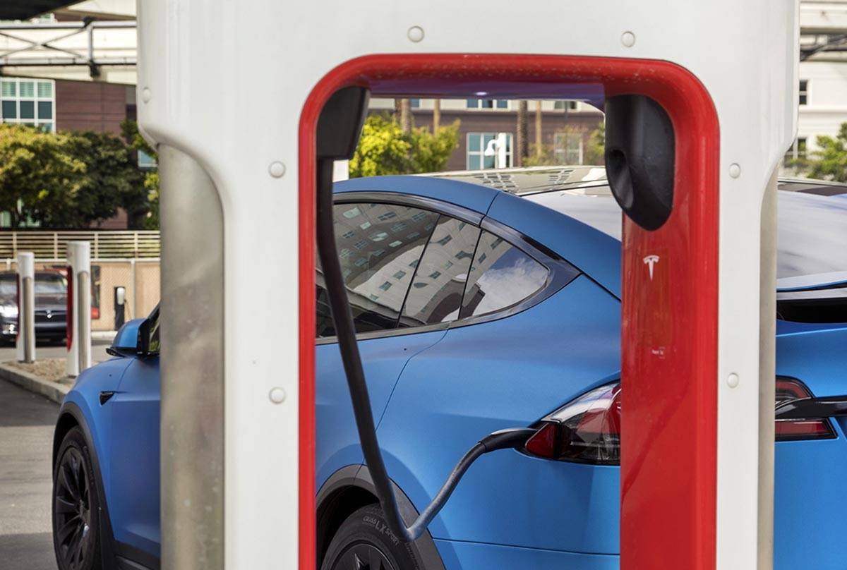 A car is plugged in at the Tesla Supercharger station near The LINQ and High Roller on Friday, ...