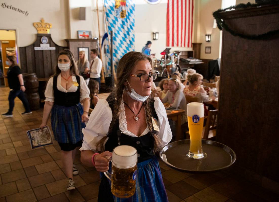 Servers deliver beer during the grand reopening of Hofbrauhaus Las Vegas on Tuesday, June 1, 20 ...