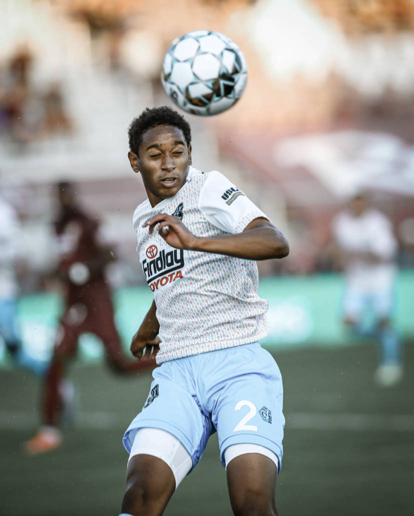 Julian Gaines heads a ball in a Lights FC road game (via Las Vegas Lights FC)