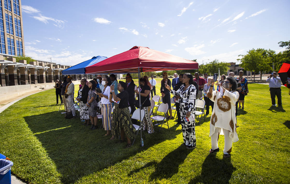 People watch as the Juneteenth flag is raised in North Las Vegas on Thursday, June 3, 2021. On ...