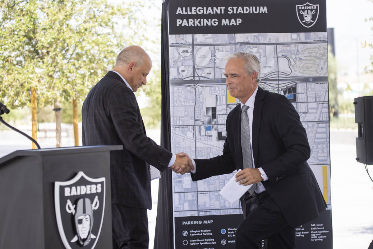 Las Vegas Raiders President Marc Badain, left, introduces Mandalay Bay hotel-casino President a ...