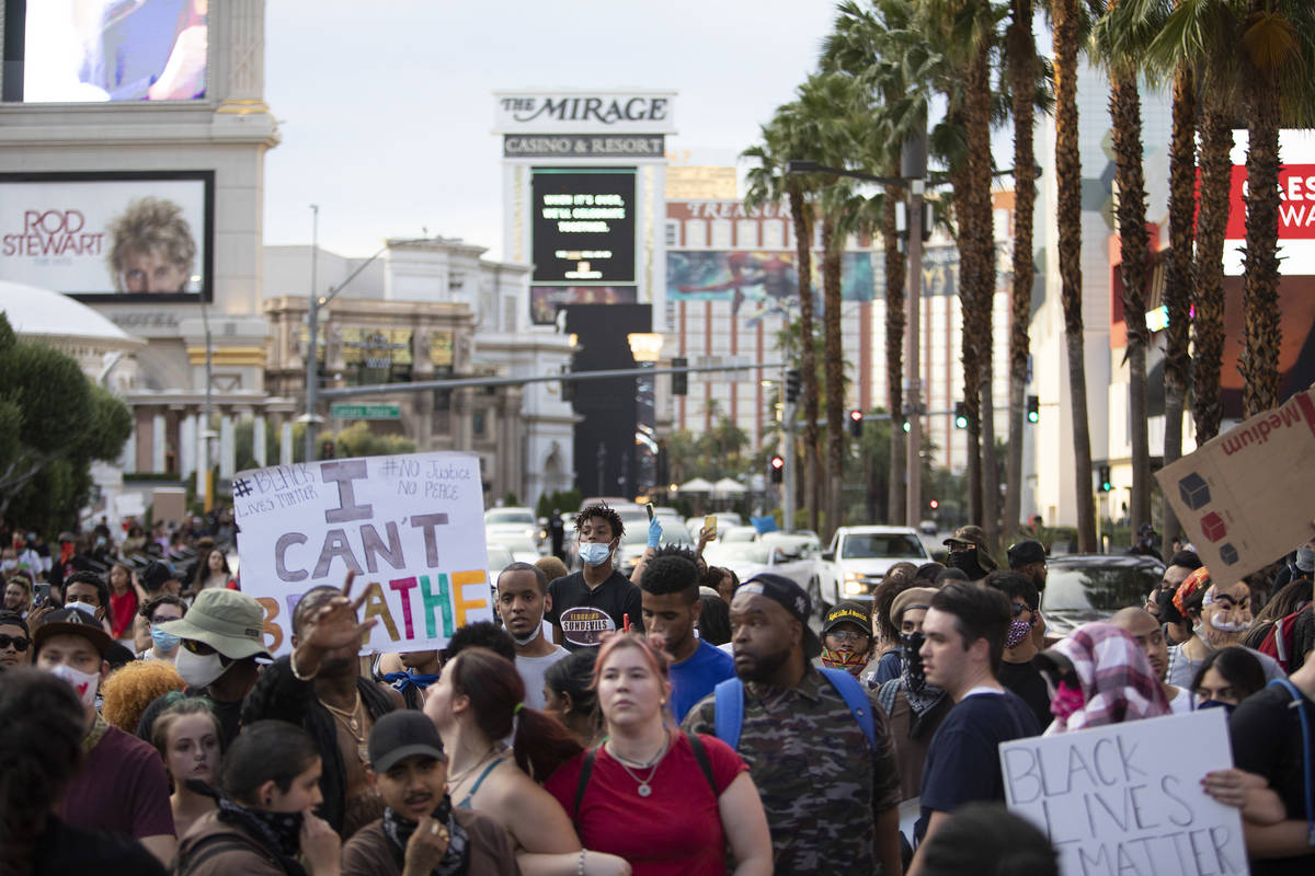 Supporters and members of the Black Lives Matter movement march down a closed-off Las Vegas Bou ...