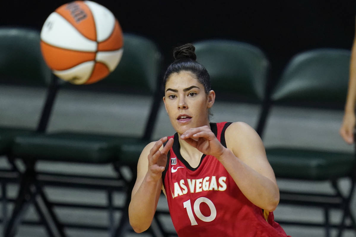 Las Vegas Aces' Kelsey Plum reaches for the ball during the first half of a WNBA basketball gam ...