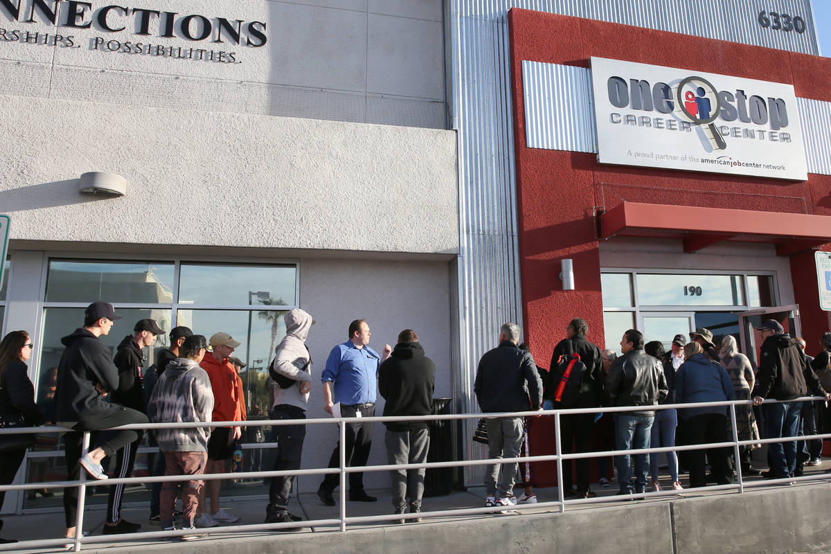 People wait in line at One-Stop Career Center on Monday, March 16, 2020, in Las Vegas. (Bizuaye ...