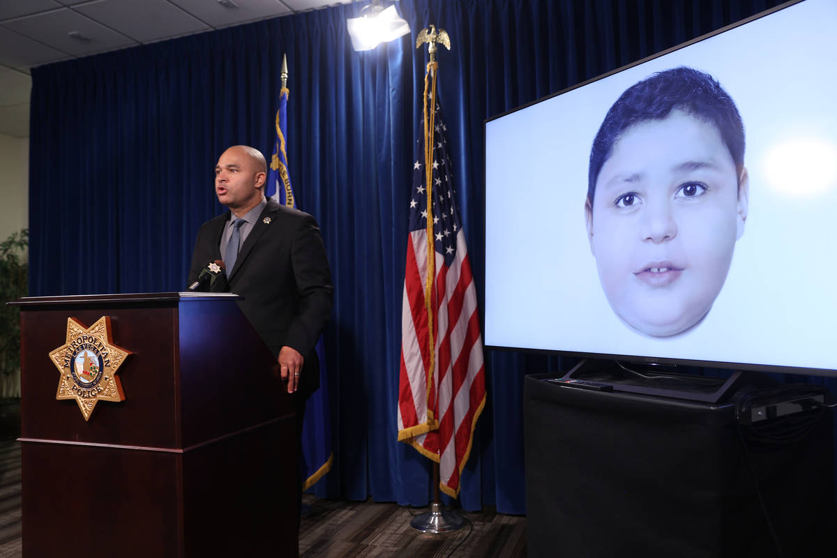 Las Vegas police homicide Lt. Ray Spencer shows a a digitally enhanced photograph of a young bo ...