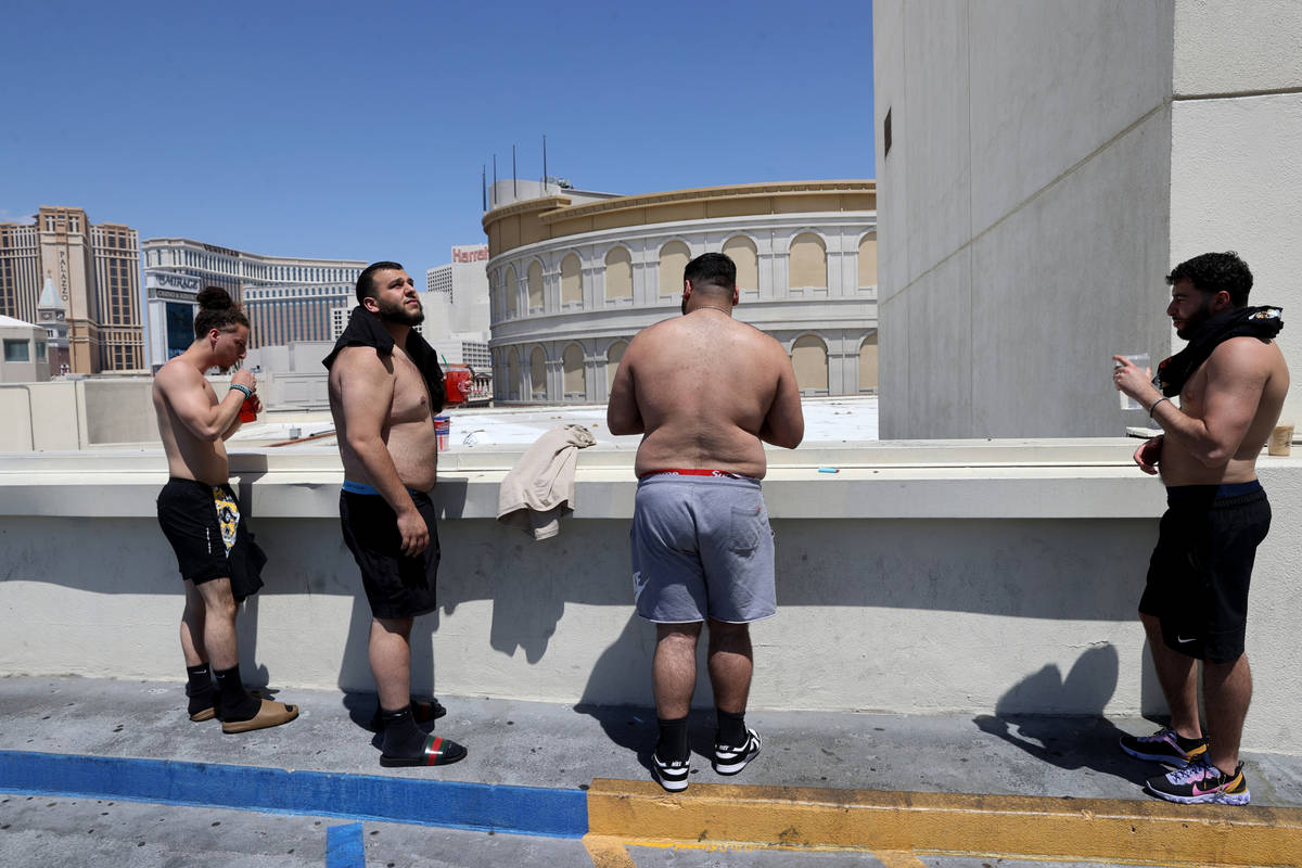 Hadi Taha, from left, Moe Baiz Ali Baiz and Alex Badawi, all of Detroit, cool off with some col ...