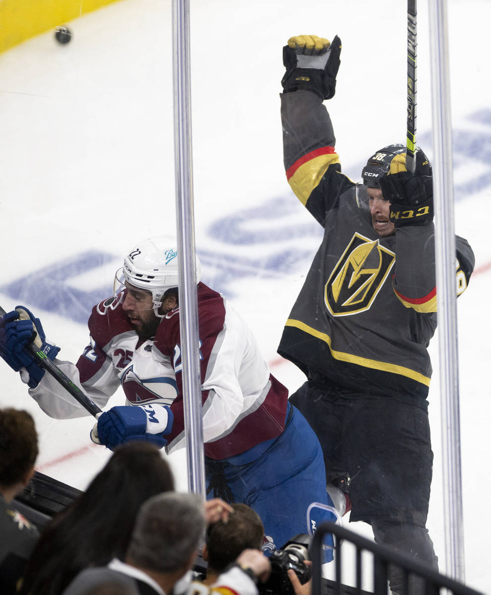 Golden Knights center Patrick Brown (38) slams Avalanche defenseman Conor Timmins (22) into the ...