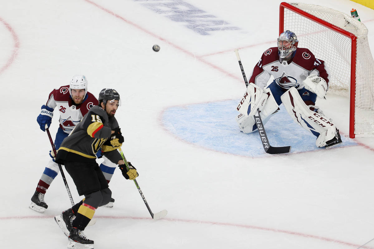 Colorado Avalanche goaltender Philipp Grubauer (31) and defenseman Devon Toews (7) defend the g ...