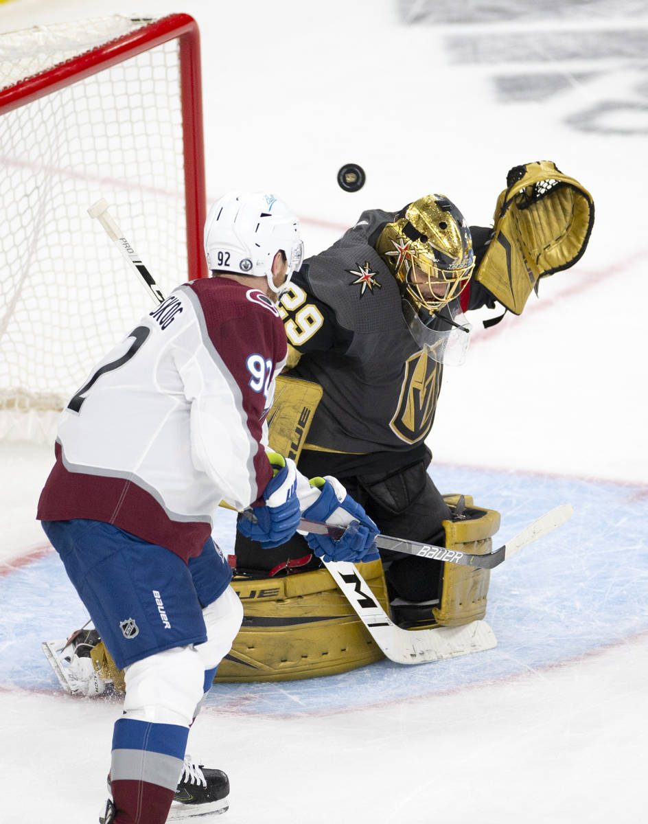 Golden Knights goaltender Marc-Andre Fleury (29) makes a save next to Avalanche left wing Gabri ...