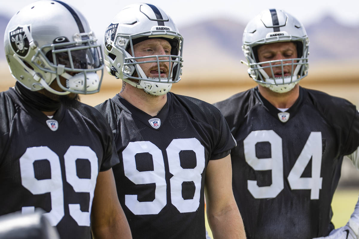 Defensive end Clelin Ferrell (99), defensive end Maxx Crosby (98) and defensive end Carl Nassib ...