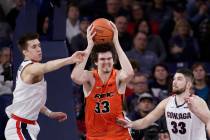 Pacific center James Hampshire, center, grabs a rebound between Gonzaga forwards Filip Petrusev ...