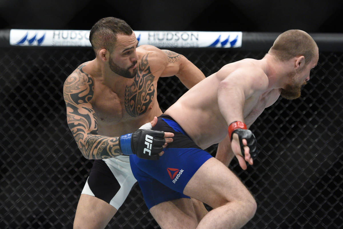 Gunnar Nelson (red gloves) fights Santiago Ponzinibbio (blue gloves) during UFC Fight Night at ...